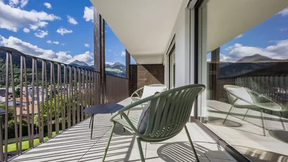 Balcony with chairs and mountain view on a sunny day